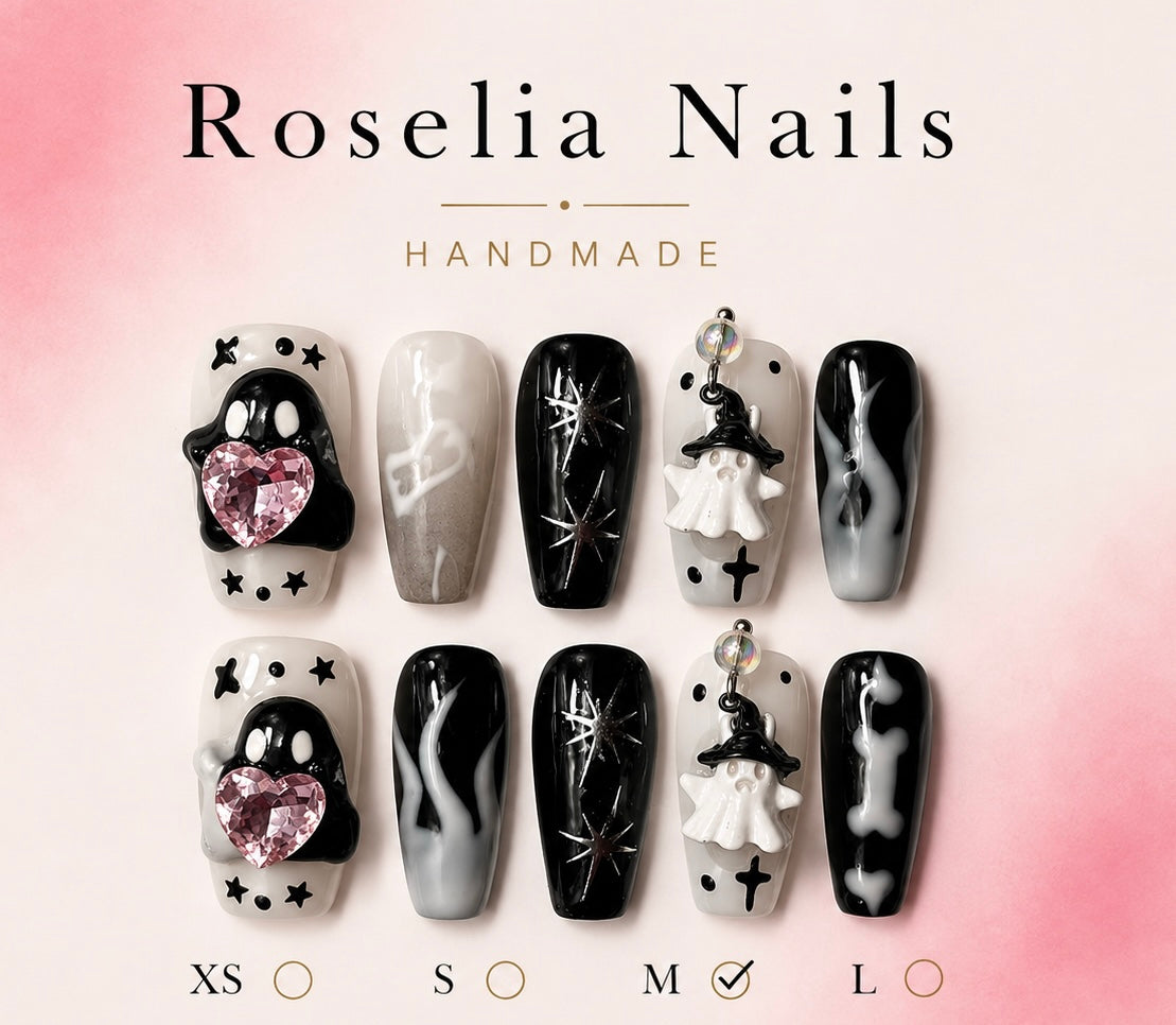Long black and white nails with a sculpted ghost and a pink heart stone